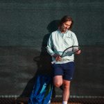 Nick Horvat looking at tennis racket